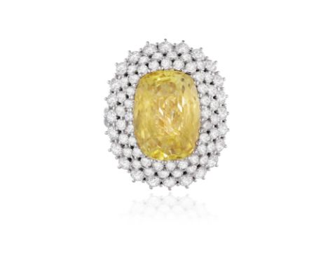 A YELLOW SAPPHIRE AND DIAMOND DRESS RINGCentring an elongated cushion-shaped yellow sapphire weighing approximately 10.00cts,