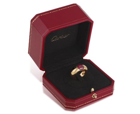 CARTIER: A GARNET DRESS RING, 1993The oval-shaped pyrope-almandite garnet weighing approximately 3.20cts, within a bombé moun