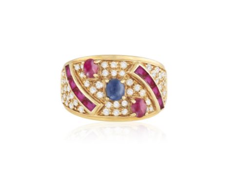 A SAPPHIRE, RUBY AND DIAMOND RING, CIRCA 1990Centrally set with an oval-shaped sapphire cabochon and two similarly-cut rubies