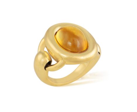 POIRAY: A CITRINE DRESS RINGThe oval-shaped citrine cabochon within collet-setting, to polished bombé frame and buckle-type h