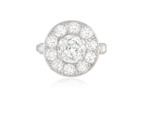 AN EARLY 20TH CENTURY DIAMOND CLUSTER RING, FRENCH, CIRCA 1920Centrally set with an old European-cut diamond weighing approxi