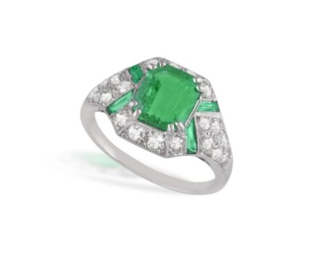 AN EARLY ART DECO EMERALD AND DIAMOND DRESS RING, CIRCA 1920The cut-cornered rectangular-cut emerald, weighing 1.36cts, withi