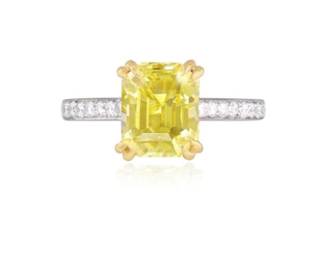 A YELLOW SAPPHIRE AND DIAMOND DRESS RINGThe cut-cornered rectangular yellow sapphire, weighing 4.02cts, between a double four