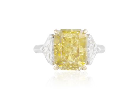 PIRANESI: A FANCY COLOURED DIAMOND AND DIAMOND RINGThe rectangular-cut Fancy Deep Yellow diamond, weighing 5.31cts, between f