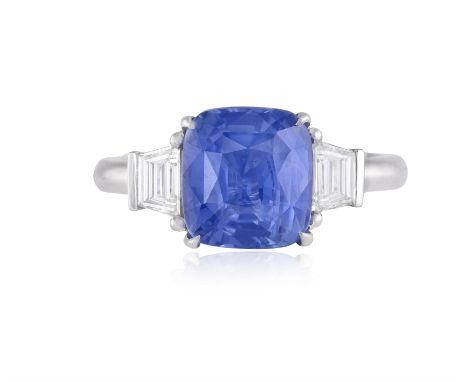 A SAPPHIRE AND DIAMOND DRESS RINGThe cushion-shaped sapphire weighing approximately 4.00cts, within a four-claw setting, to a