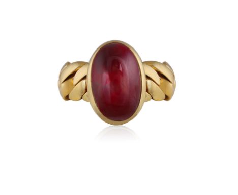 POMELLATO: A GARNET RINGThe oval-shaped cabochon garnet within collet and closed-back -setting, to a curb-link chain, mounted