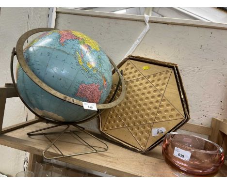 A globe on stand together with a wooden solitaire board