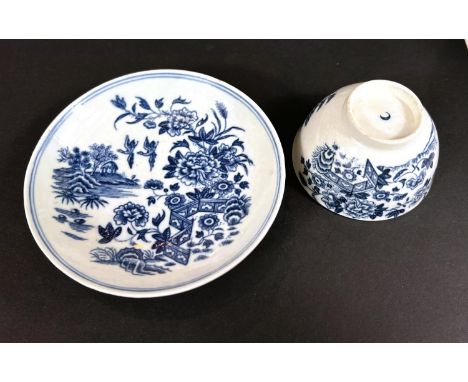 A First Period Worcester soft paste porcelain in blue and white tea bowl and saucer, garden scene, crescent mark to base&nbsp