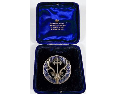 A large Scottish enamel and white metal Stag head brooch with cross on head, dia. 4cm in associated box 