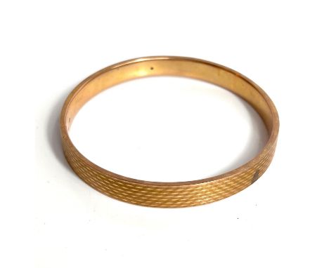 A 9ct gold (wax filled) bangle, 20.4gn gross, a crystal set ankle chain 