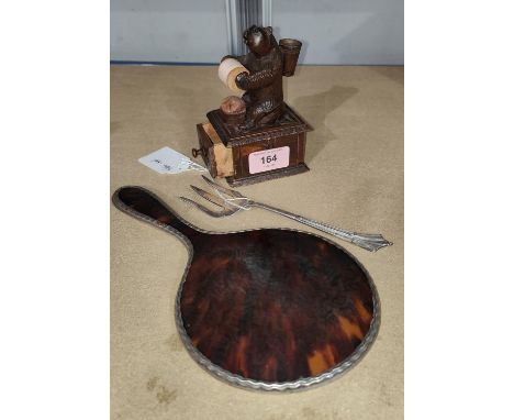 A Black Forest carving of a seated bear with pin cushion and thread spool, ht. 13cm; a tortoiseshell and silver hand mirror