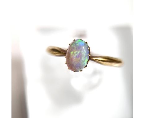 A yellow metal opal set ring, 2.5gm, length of opal 6.5mm 