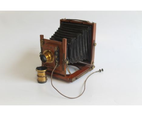 AN EARLY 20TH CENTURY MAHOGANY FOLDING CAMERA, together with a 'A & E Auxiliary CS Ltd' lens and another unbranded type 