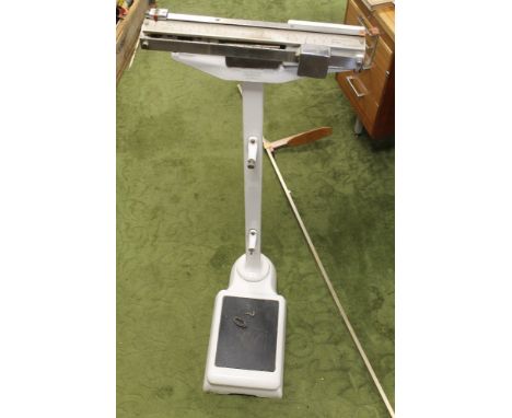 A SET OF AVERY HOSPITAL TYPE SCALES, up to twenty stone with white enamel finish, together with a height rule up to six foot.