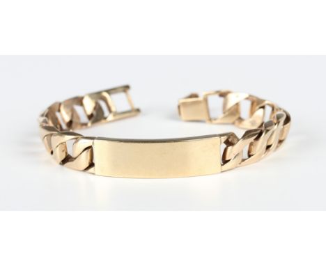 A 9ct gold faceted curblink identify bracelet with a curved panel to the front, with a foldover clasp, London 1977, weight 63