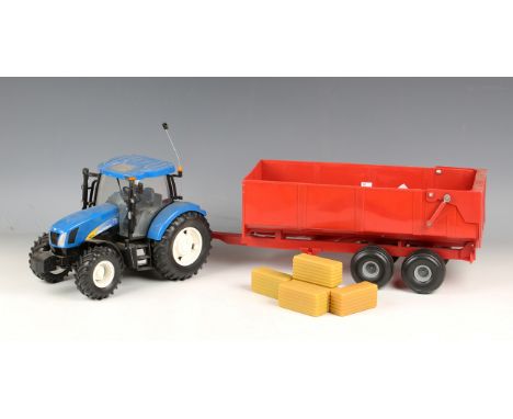 A Britains Big Farm radio control New Holland T6070 tractor and a bulk tipping trailer, both boxed (boxes creased, torn and s