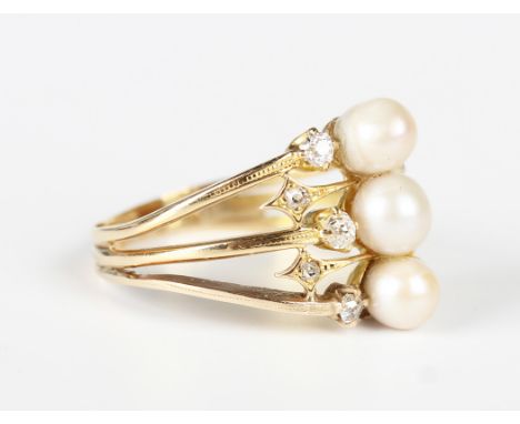 A gold, diamond and cultured pearl ring in a triple shank design, mounted with three cultured pearls and five cushion cut dia