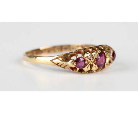 An Edwardian 18ct gold, ruby and diamond ring, mounted with three rubies and two rose cut diamonds, Chester 1908, weight 2.1g