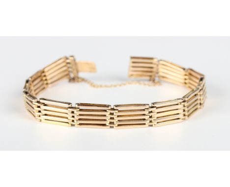 A gold bar and oval link gate bracelet on a snap clasp, detailed '15', weight 17g, length 17.8cm.Buyer’s Premium 29.4% (inclu