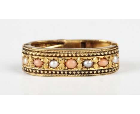 A Victorian gold half-pearl and coral set oval sprung scarf clip, mounted with a row of alternating half-pearls and corals be