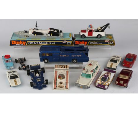 A collection of diecast vehicles, including a Dinky Toys No. 442 Land Rover breakdown crane, a No. 672 missile boat, both wit