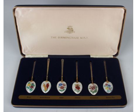 A set of six Elizabeth II Birmingham Mint silver gilt and enamel collector's spoons, each bowl back painted with a different 