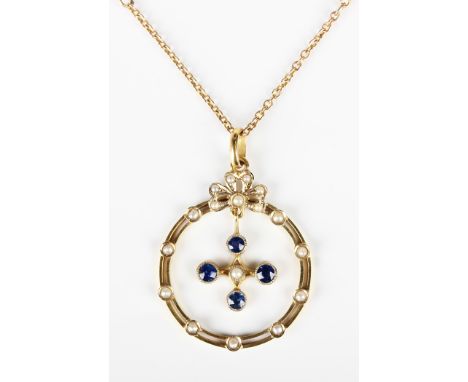 A gold, sapphire and seed pearl pendant, circa 1910, in a circular openwork design, the swing centre mounted with four sapphi