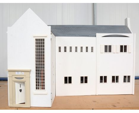 A modern Arts and Crafts style doll's house, the hinged double-front revealing a staircase and four rooms, height 80cm, width