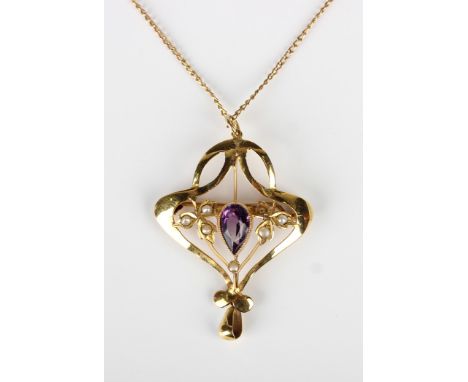 A gold, amethyst and seed pearl pendant brooch, mounted with the pear shaped amethyst between two trefoil shaped sides, mount