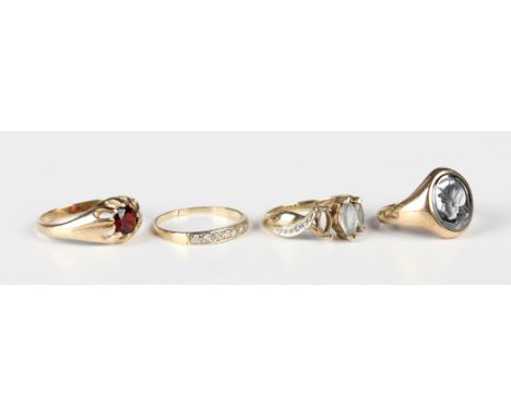 A 9ct gold ring, claw set with a circular cut garnet, ring size approx Q, a 9ct gold and oval haematite intaglio, designed as