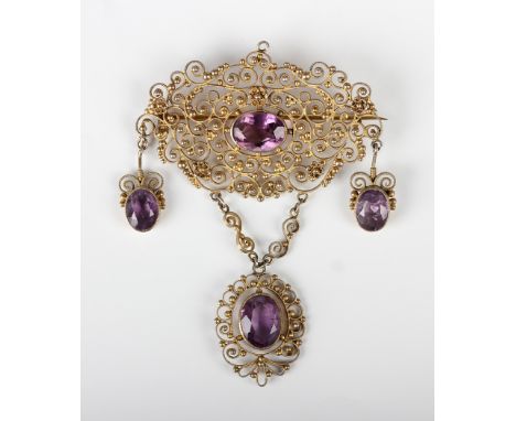A silver gilt and amethyst brooch in a cannetille work design with three pendant drops, unmarked, weight 14.6g, width 5.8cm, 
