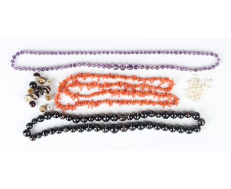 A single row necklace of graduated faceted amethyst beads with faceted colourless paste spacers at intervals, length 76cm, a 