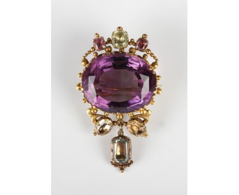 A Victorian gold, amethyst and foil backed varicoloured gem set brooch, claw set with the oval cut amethyst to the centre wit