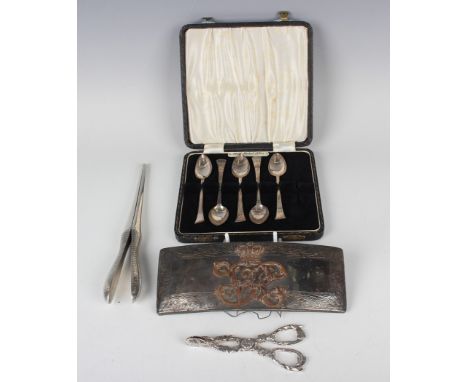 A group of silver items, comprising a pair of Victorian sugar tongs, cast in a fruiting vine design, London, date letter rubb