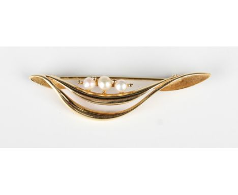 A gold and cultured pearl bar brooch in a curved design, mounted with three cultured pearls, detailed '18kt', weight 6g, widt