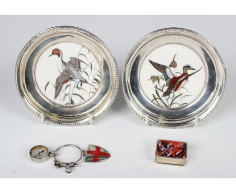 A pair of American sterling mounted porcelain circular pin dishes, each centre decorated with a printed duck amongst reeds, b