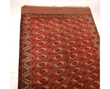 
	
		A large Turkmen rug, possibly Tekke, with 4 rows of 12 guhls, flatweave panel ends, approximately 358 by 220cm overall.
