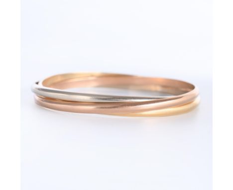14 kt. Gouden stijve armband. Naar het model 'Trinity'van Cartier. Bestaande uit drie losse banden, één in rood, één in wit e