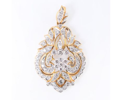 18 kt. Gouden hanger, met centraal een bloem omgeven met krullen en bladmotieven. Het geheel rijkelijk bezet met briljant ges