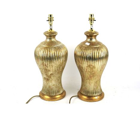 A pair of contemporary gilt finish table lamps. Ceramic, of baluster form with fluted gold finish, H50cm 