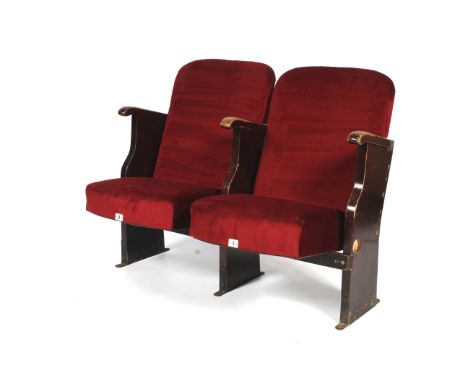 A pair of vintage conjoined cinema seats. Upholstered in dark red velvet, with stained wooden frames, bearing numbers 1 &amp;
