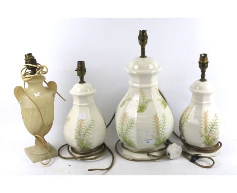 A set of three table lamps and one other. Three ceramic lamps with fern decoration on a cream ground, max H34cm, and a marble