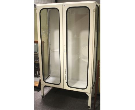 A vintage 1970s white painted glazed metal medical cabinet. With glazed double doors flanked by glazed sides, with adjustable