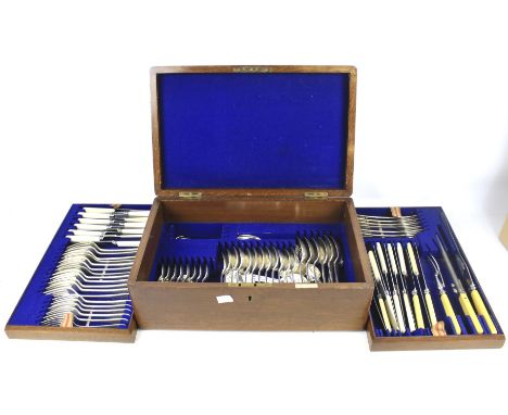 A vintage Walker and Hall oak cased canteen of silver plate cutlery. With two lift out trays, L42.5cm x D27cm x H15cm