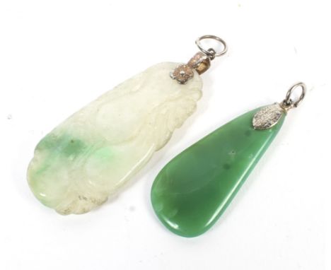 Two jade pendants. One green and the other white and carved with a flash of green.