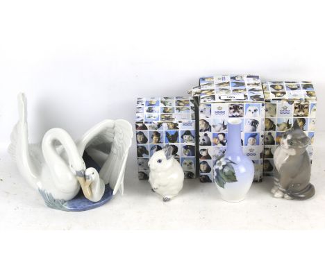 A collection of four 20th century porcelain figures. Including Nao swan and signet #1358 plus three boxed Copenhagen ornament