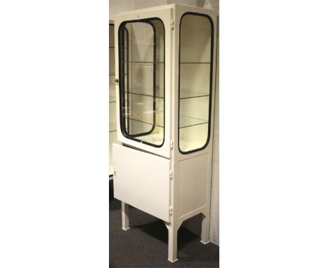 A vintage 1970s white painted and glazed metal medical cabinet with cupboard. With glazed lockable door and sides enclosing a