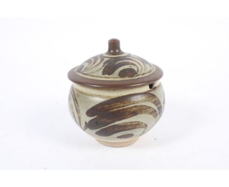 A Bernard Leach St. Ives studio pottery jam pot and cover. The stoneware footed preserve pot, decorated with abstract foliage