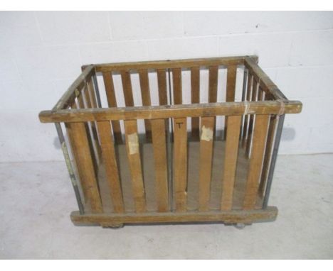 An industrial slatted wooden bobbin trolley