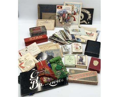 A collection of various vintage ephemera including cigarette cards, greetings cards, postcards, playing cards, bank notes, tw
